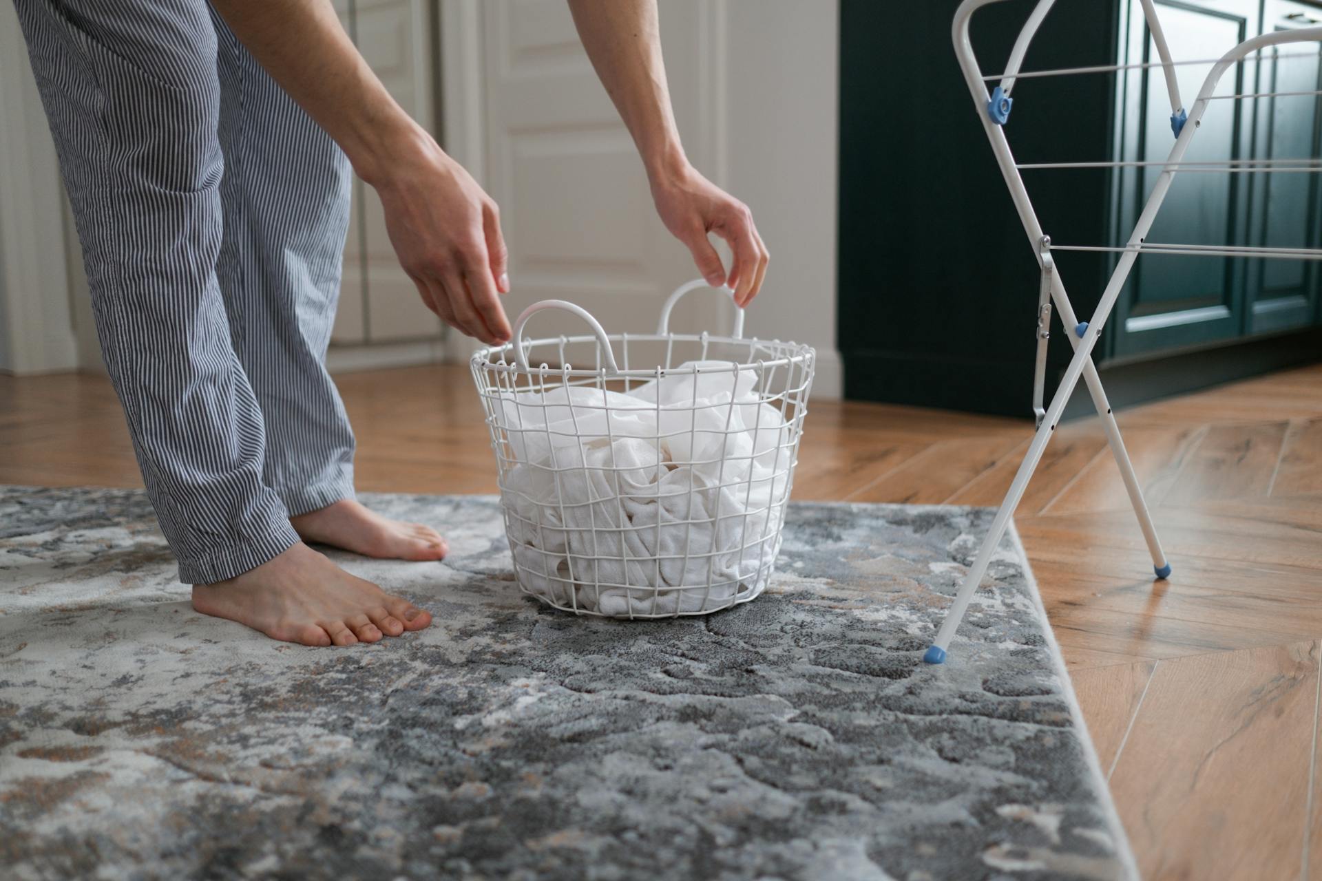 Person picking up laundry basket