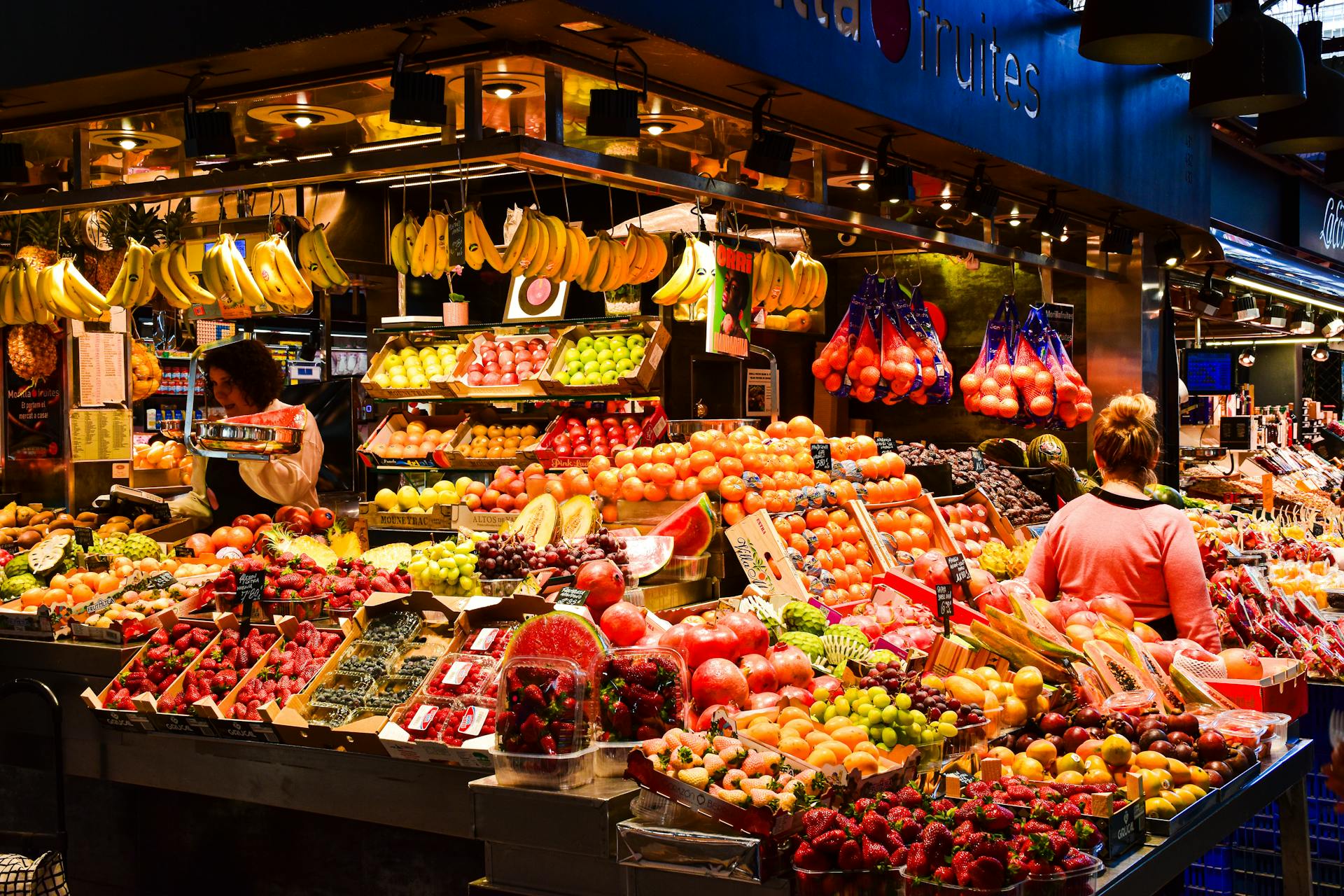 Stall selling fresh produce at La Boqueria food market.
